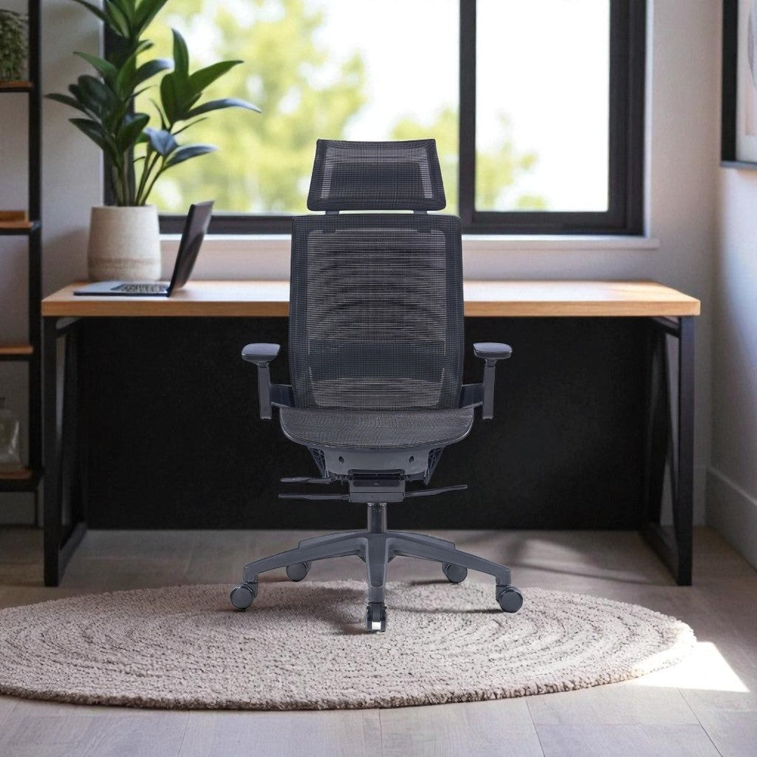 black office chair in a home office setting with a desk and plants.