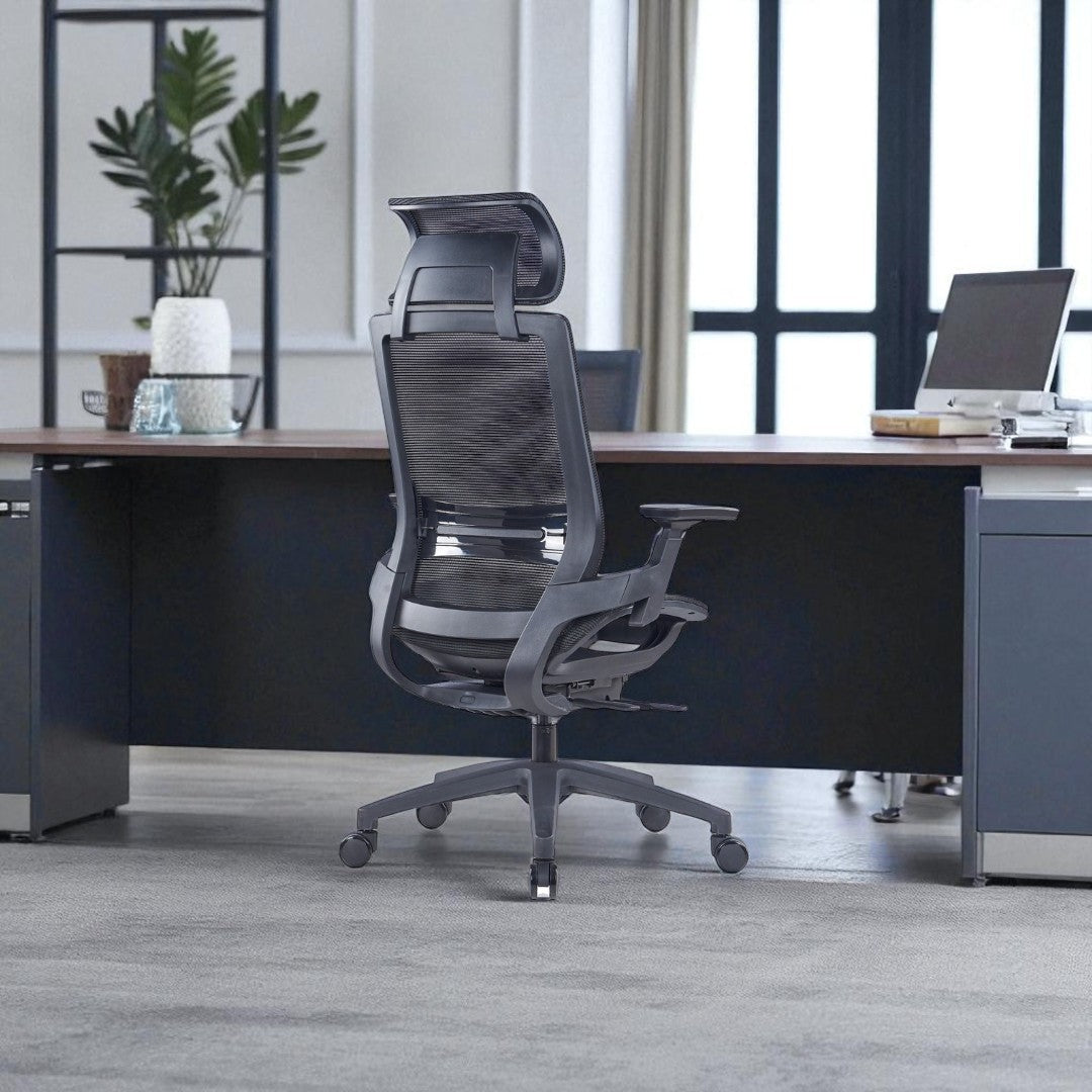 black office chair in front of a desk with a modern office setting.