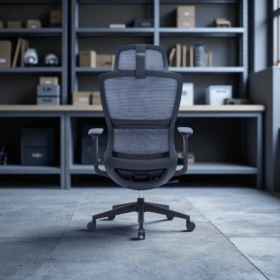 Gray office chair in a room with shelves and a desk.
