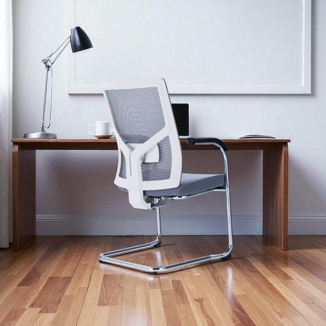 Modern office chair in front of a wooden desk with a lamp and cup.