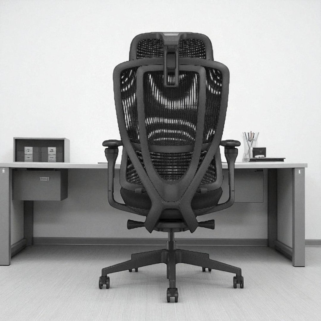 Black office chair in an office setting with a desk and white walls.