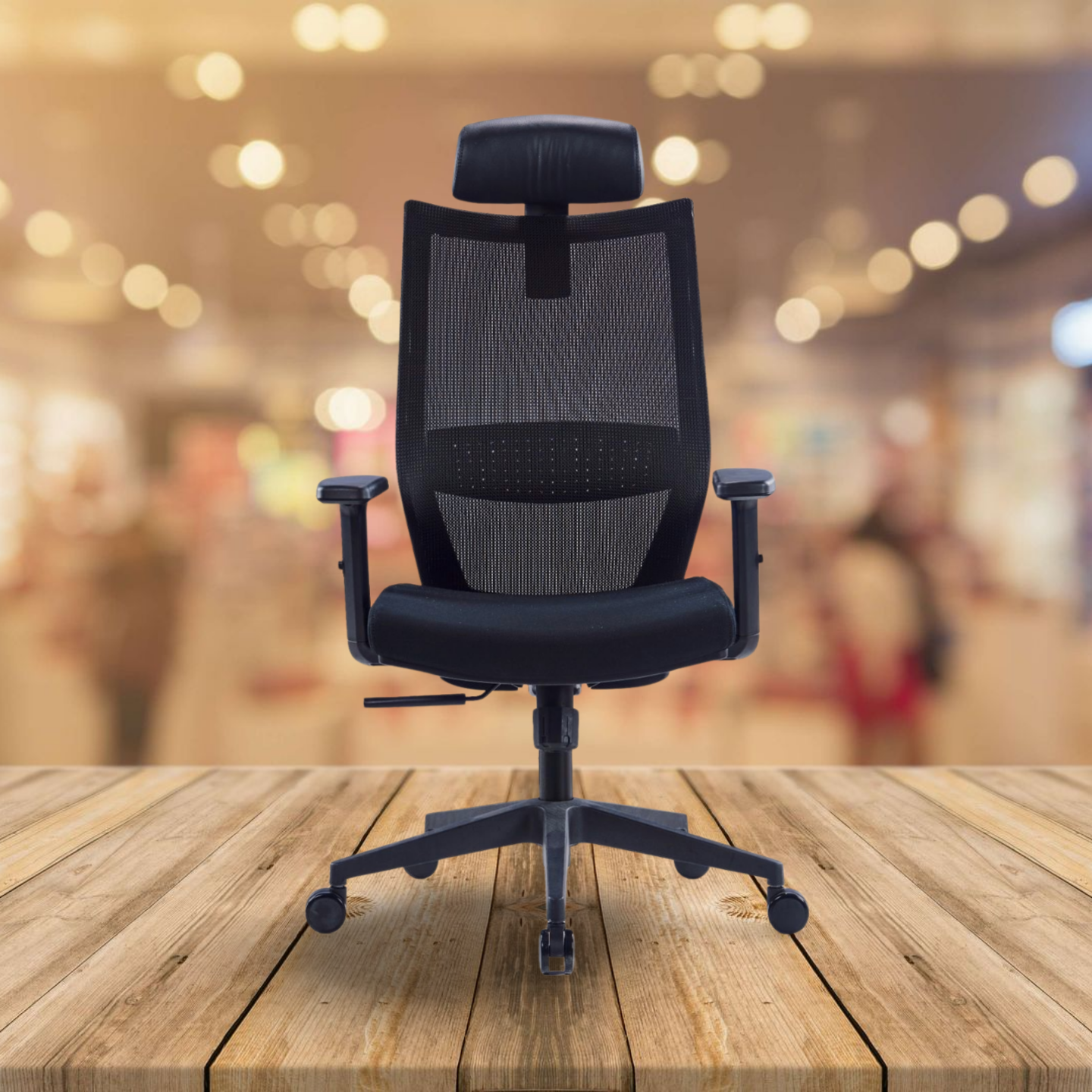 Black office chair on a wooden floor with a blurred indoor background