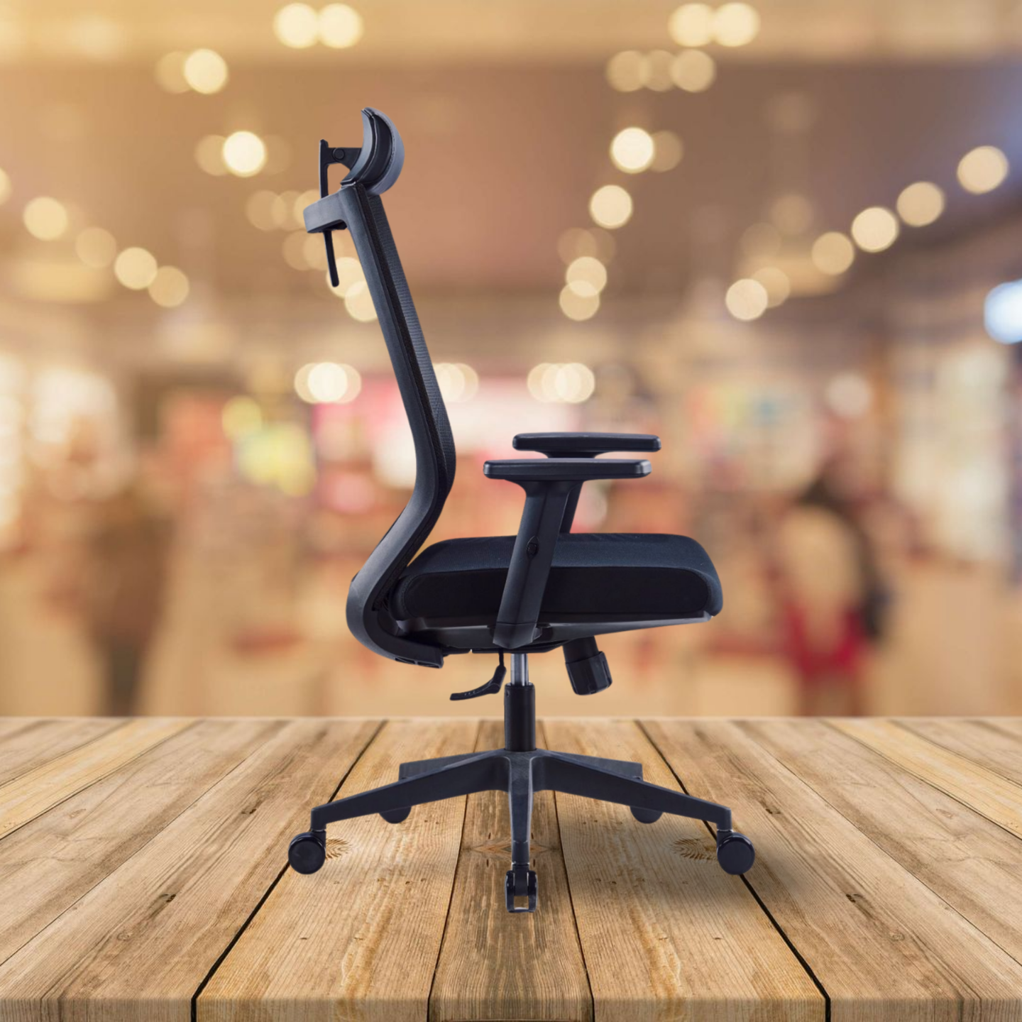 Black office chair on a wooden surface with a blurred indoor background