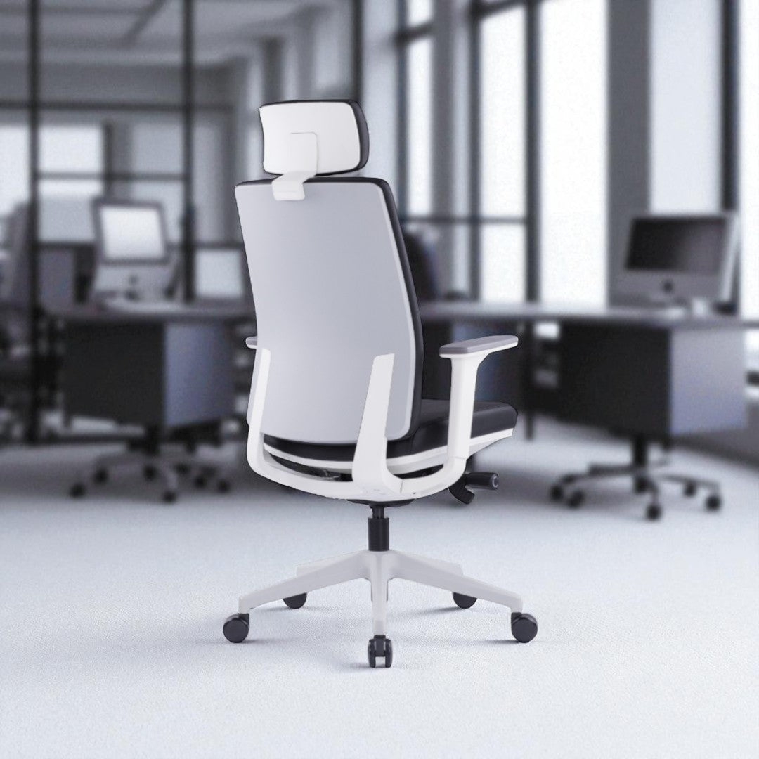 White office chair in a blurred office setting with desks and computers.