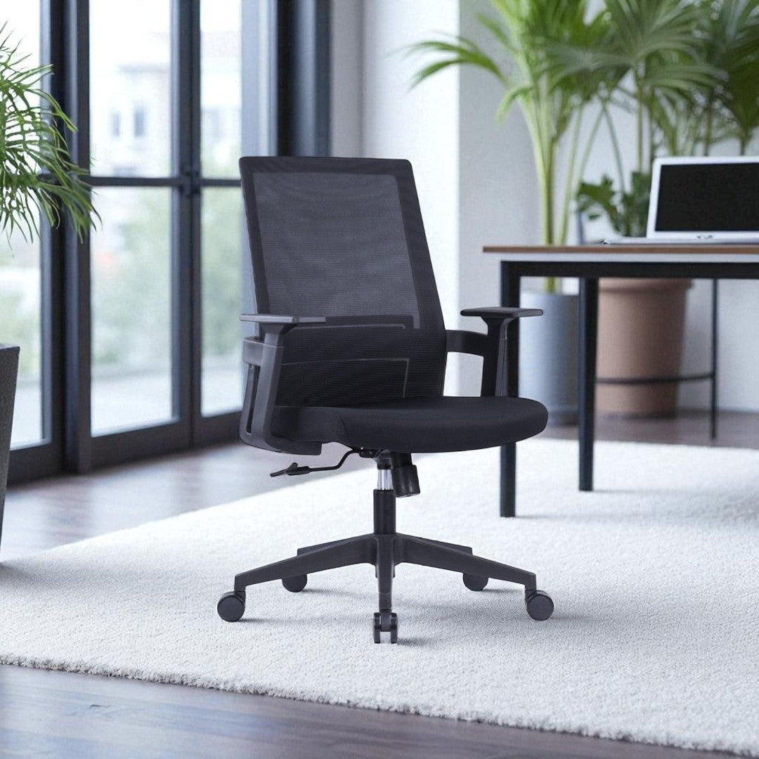 Black office chair in a modern office setting with a desk and plants.