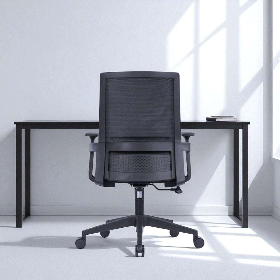 Black office chair in front of a desk in a bright room