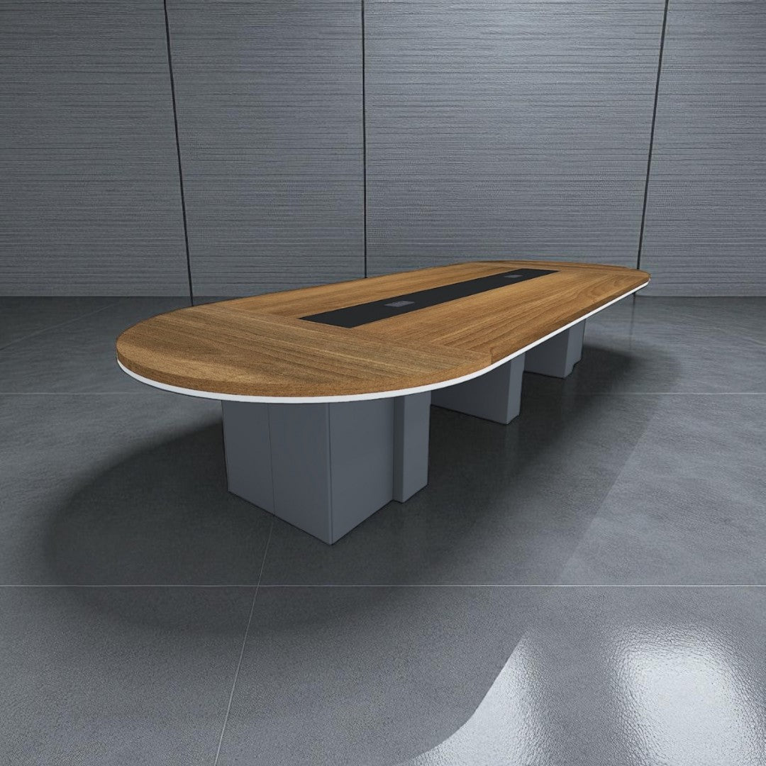 Oval conference table with wooden top and gray base in a room with gray walls and floor.