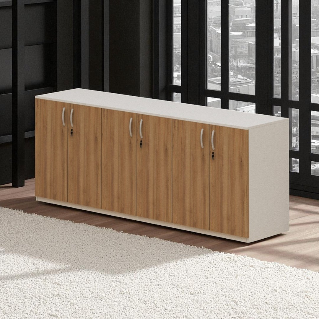 Wooden cabinet with white top in a room with large windows