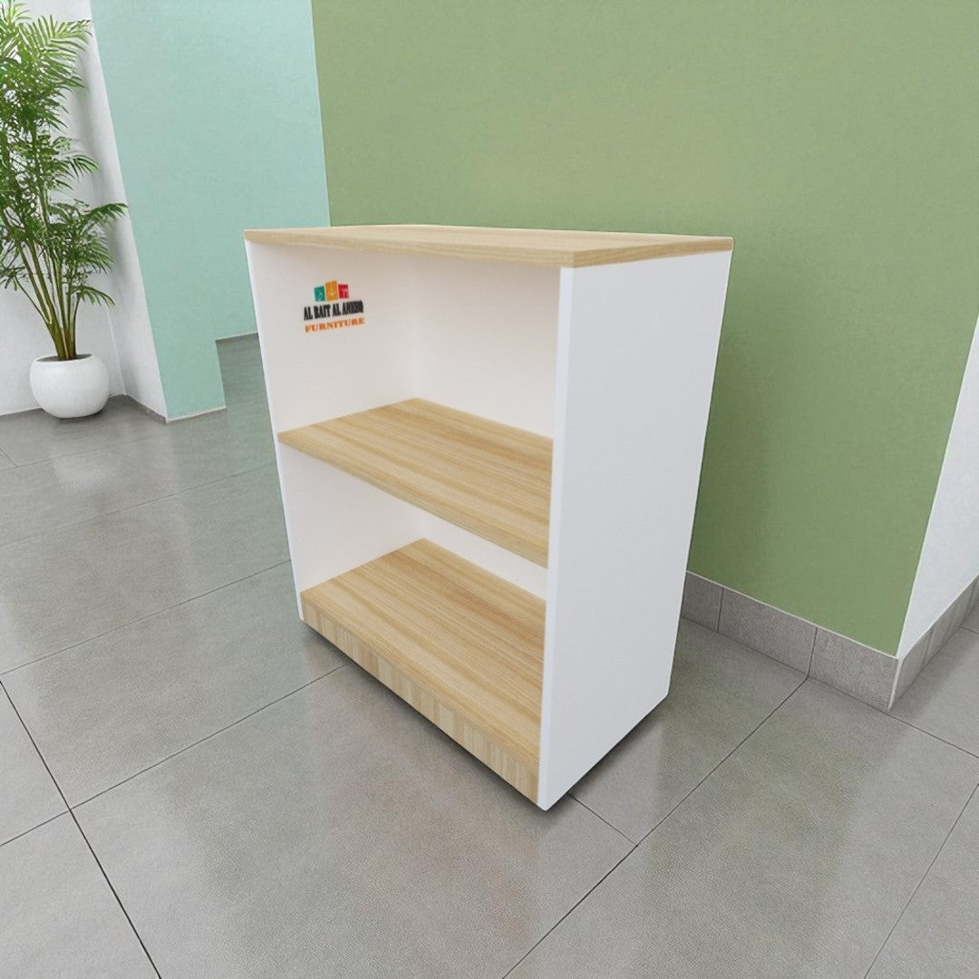White and wooden reception desk against a green wall with a plant on the left.
